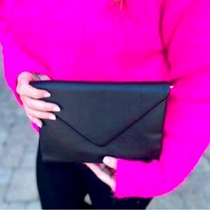 black envelope clutch with gold chain shoulder strap